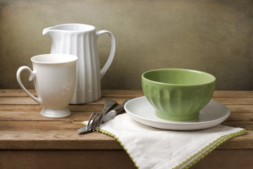 Still life with white and green tableware arrangement