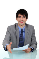 A businessman about to shake hand.