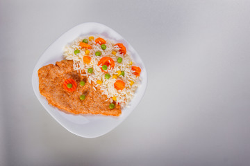 Above shot of fried chicken fillet with side dish