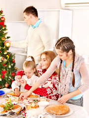 Children rolling dough in kitchen.
