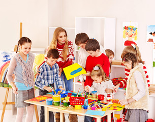 Child painting at art school.