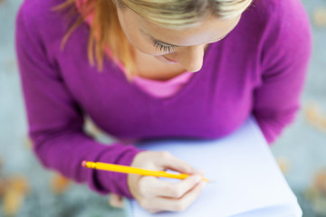 Female student writing in notebook