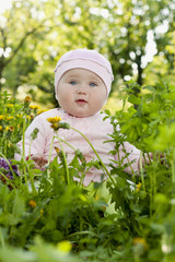 little girl on a background of green grass