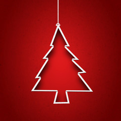 Paper cut to form christmas tree on red background