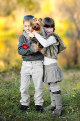 Naklejka na ściany i meble portrait of little boy and girl outdoors in autumn