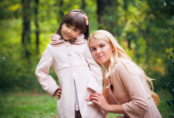 Fototapeta premium happy young mother with the daughter in park