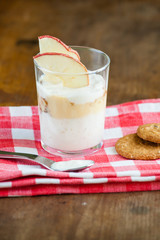 Yogurt dessert with vanilla sauce and biscuit crumble