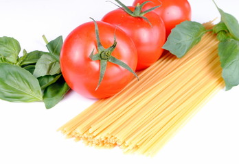 raw spaghetti, tomatoes and basil on white,  soft shadows