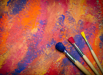 Paintbrushes on abstract grange background