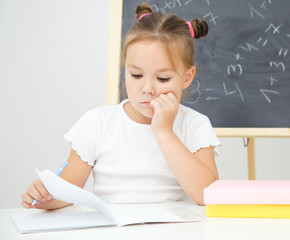 Little girl is studying