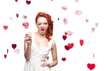 Obraz na płótnie Canvas winking red-haired woman holding lollipop