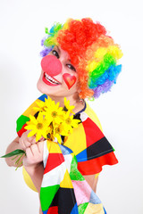 Clown looking to the copy space area in a white studio