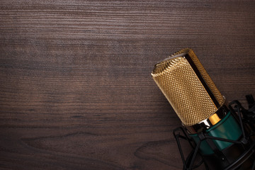 vintage condensing microphone on the wooden background