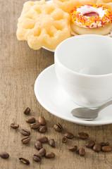 cup with coffee beans at table
