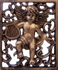 Relief of an angel and ornaments - obrazy, fototapety, plakaty