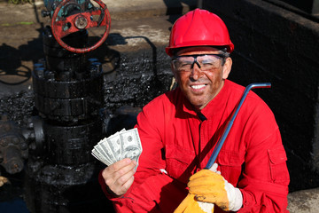 Satisfied Worker Holding Money at Oil Field