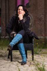 Urban fashion portrait of pretty woman with black hair.