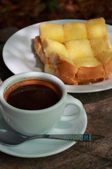 Pour a cup of coffee, bread, butter, milk and sugar