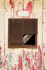 Rusty air vent in an old peeling door background