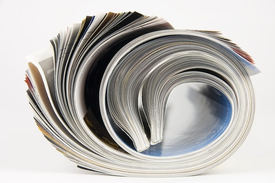 Rolled up magazines over white background