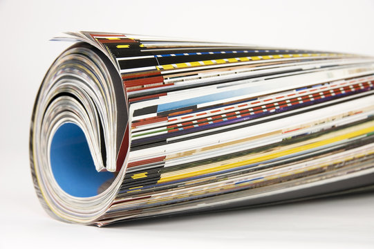 Rolled up magazines over white background
