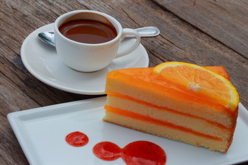 Orange cake with strawberry jam and hot coffee