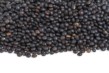 Heap of black lentil isolated on white