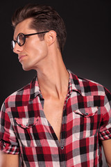 profile of a casual young man wearing glasses