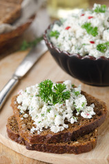 pate of cottage cheese with herbs and chili peppers on a piece o