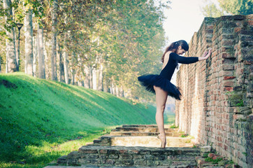 Young beautiful ballerina dancing outdoors in Ferrara.