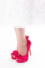 Close up of womans feet in stilettos on white background.