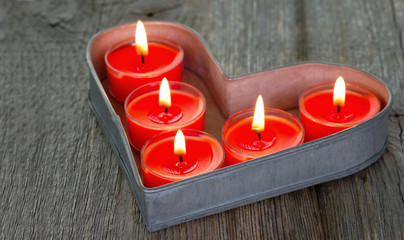 Red burning candles on a tray