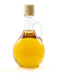 bottle with yellow liquid in a white background