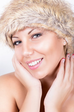 Beautiful woman wearing brown fur hat