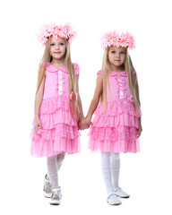 Two beautiful little girls in pink dresses