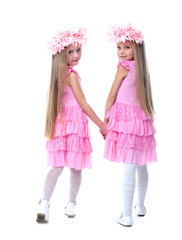 Little girls in pink dresses