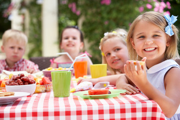 Group Of Children Enjoying Outdoor Tea Party