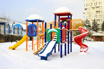 Colorful playground after winter snow