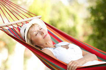 Senior Woman Relaxing In Hammock