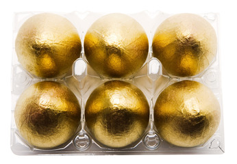 Six golden eggs in carton