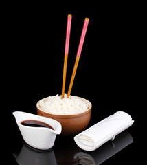Bowl of rice and chopsticks isoalted on black
