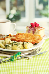 Roast chicken cutlet with boiled potatoes , cup of tea and