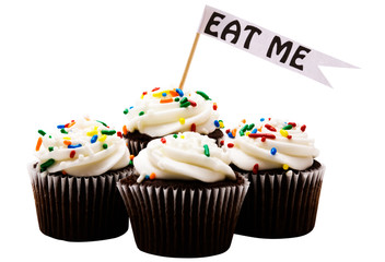 Close-up of EAT ME tag on cupcakes