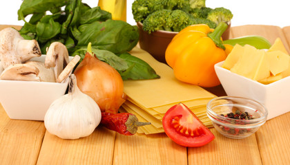 Vegetarian lasagna ingredients on wooden background