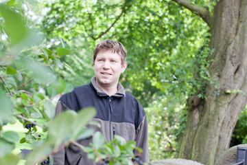 young man dreaming in summer garden