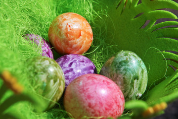 Painted Colorful Easter Egg in green basket