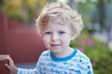 Beautiful toddler boy on balcony