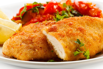 Fried chicken fillets and vegetables