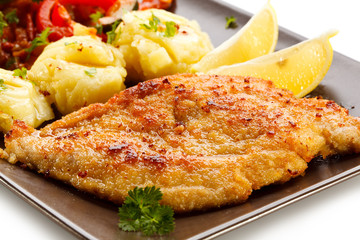 Pork chops, mashed potatoes and vegetable salad