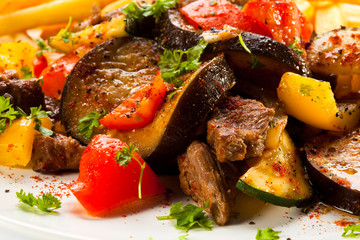 Roasted meat, French fries and vegetables